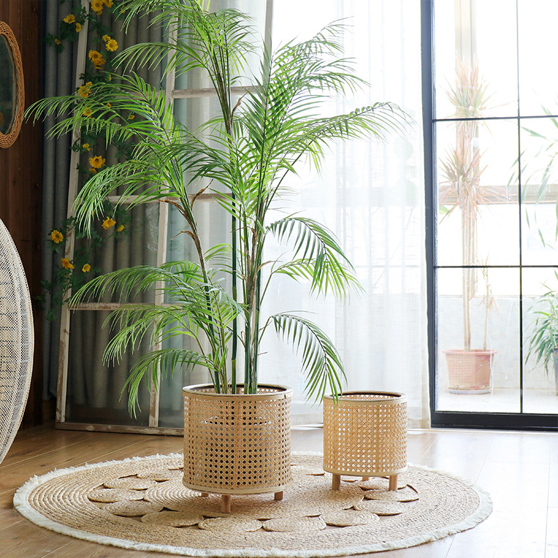 Woven basket stands arranged beside a window